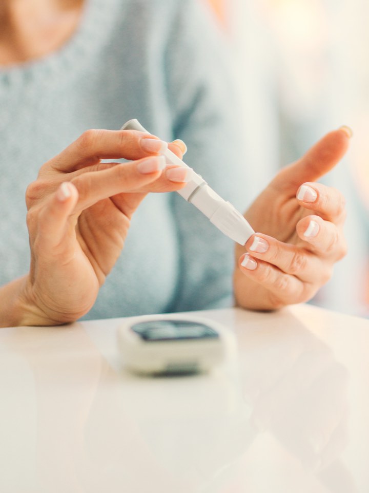 Woman testing her blood sugar