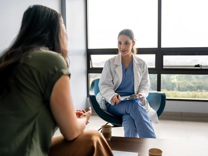 A specialist medical provider meets with a patient