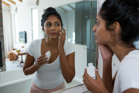 Woman applying sunscreen