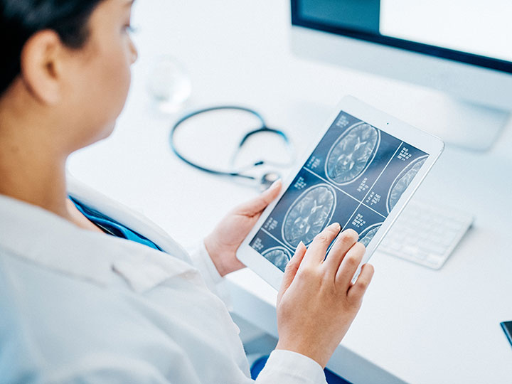Iowa neurologist reviewing brain activity with advanced technology